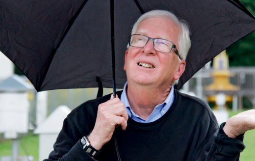 Alt=David Phillips Under an Umbrella 
